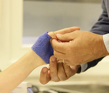Checking the fit of a thumb immobilization orthosis in Orficast blue.